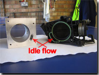 Idle by-pass block with throttle body showing by-pass flow - Click for larger image